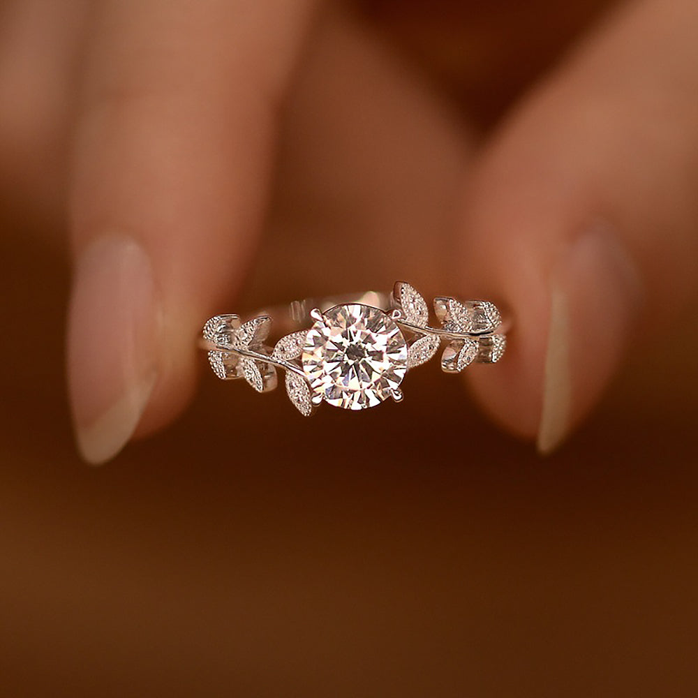 Moissanite ring with a round centre stone and leaf-detail band